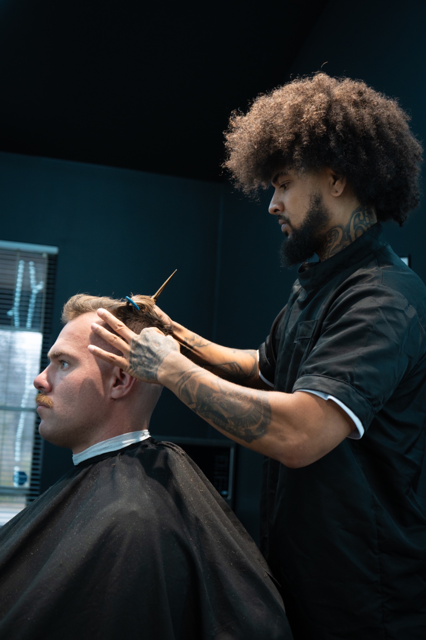 Justin Nicks cutting a client at Winners Circle Barbershop