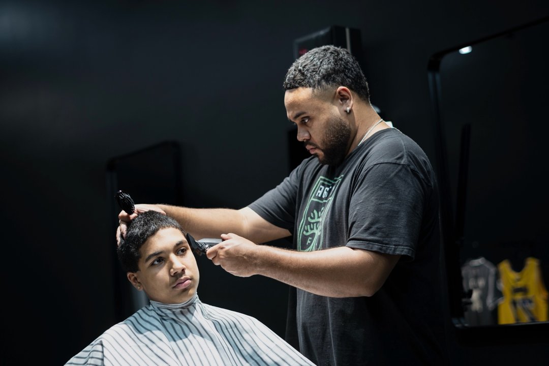 Devry Weaver cutting a kid at Winners Circle Barbershop